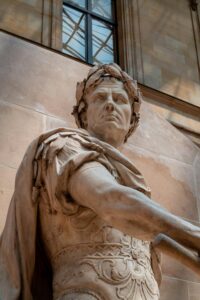 Elegant Roman sculpture of Julius Caesar in marble, inside a museum environment. Captures the detail and artistry of ancient history.